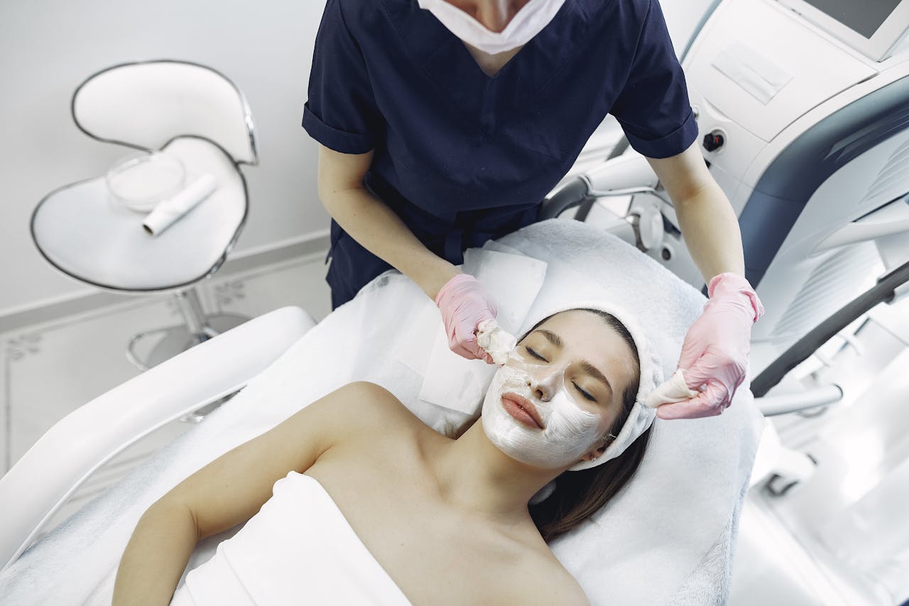 A woman receives a rejuvenating facial treatment at a modern spa clinic.